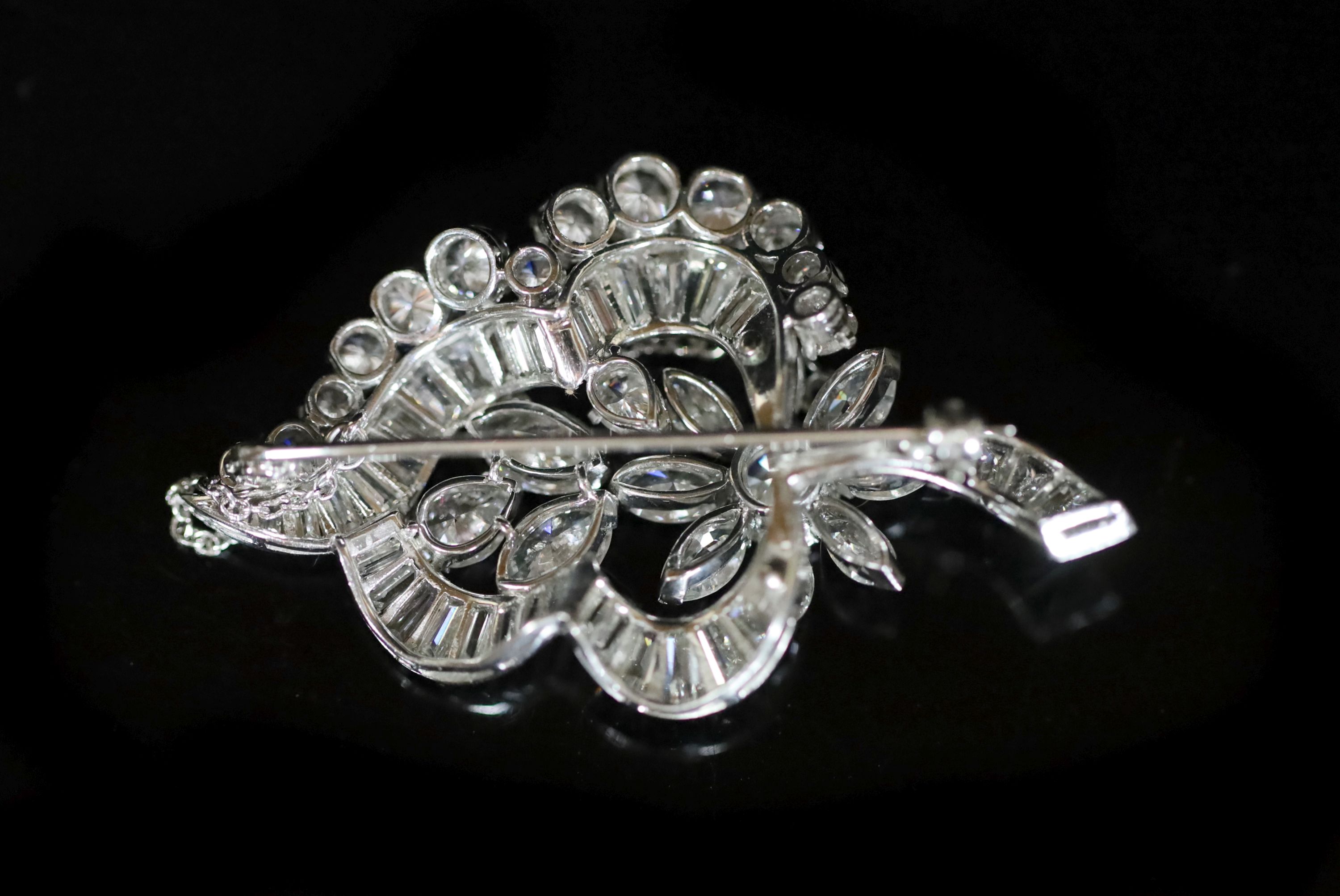 A 1960's white gold and diamond flower design brooch,